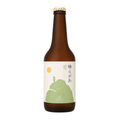 A brown glass bottle of sake with a white label featuring a green mountain illustration and Japanese text, topped with a gold cap, shown on a checkered gray background.