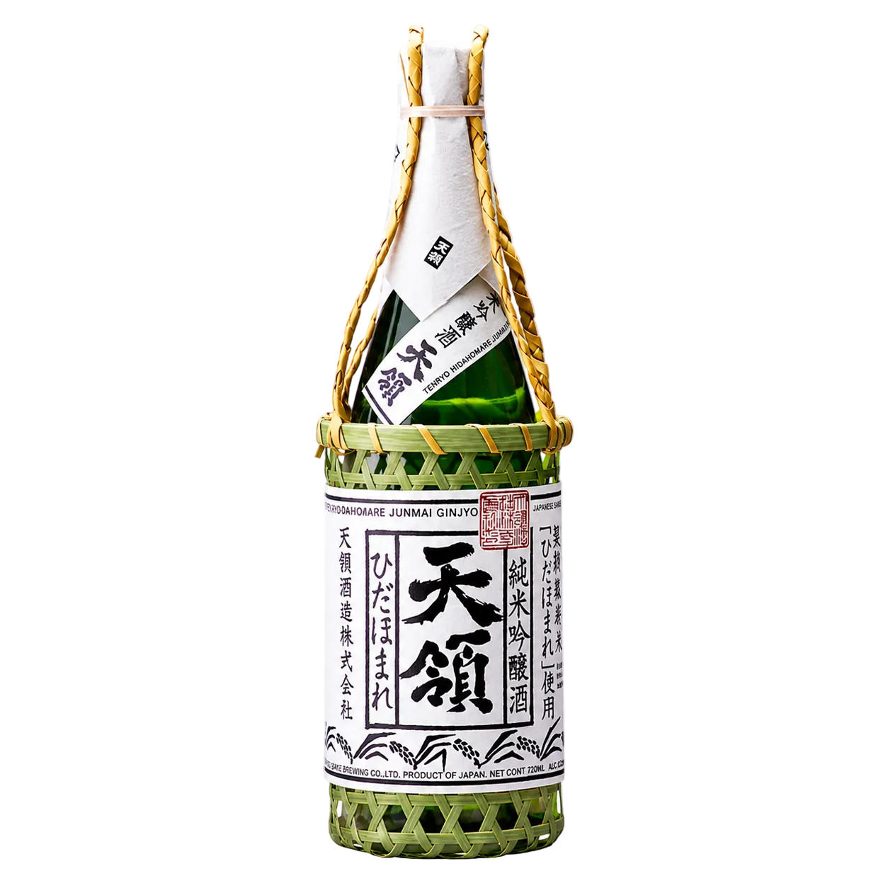 A bottle of Japanese sake in a woven green bamboo carrier basket, shown against a white and gray checkered background. The bottle has a white paper label with black Japanese characters and a gold neck wrap.